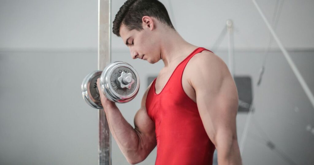 A man in Gym doing Biceps